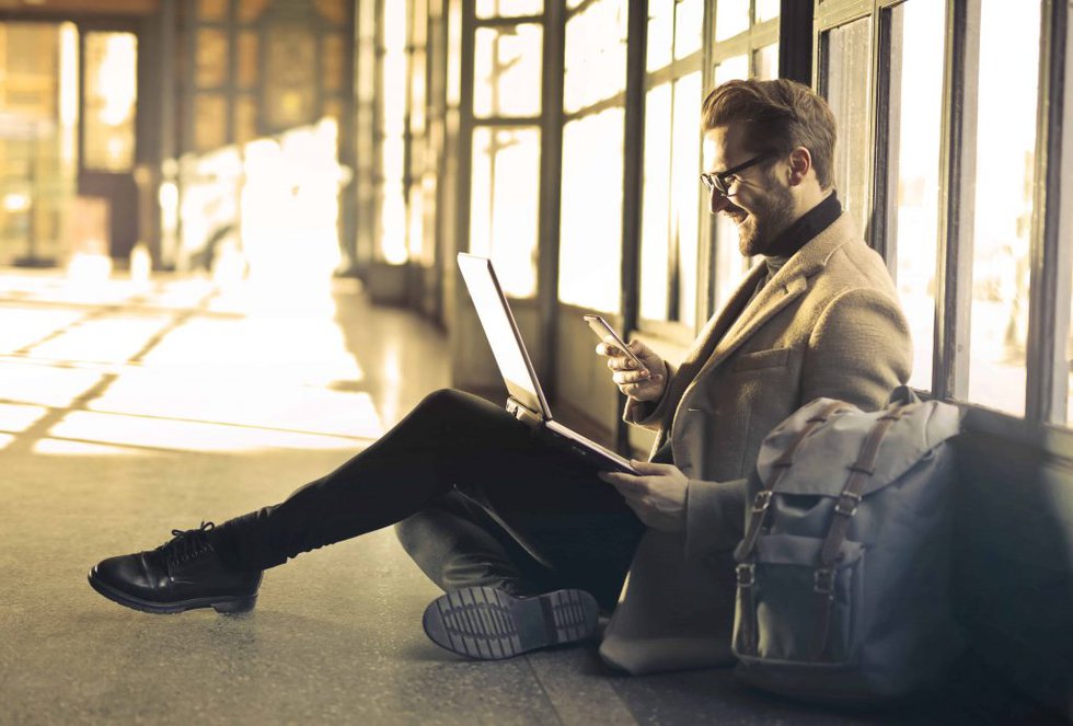 man checks phone for man checks phone as translation can help your business thrive