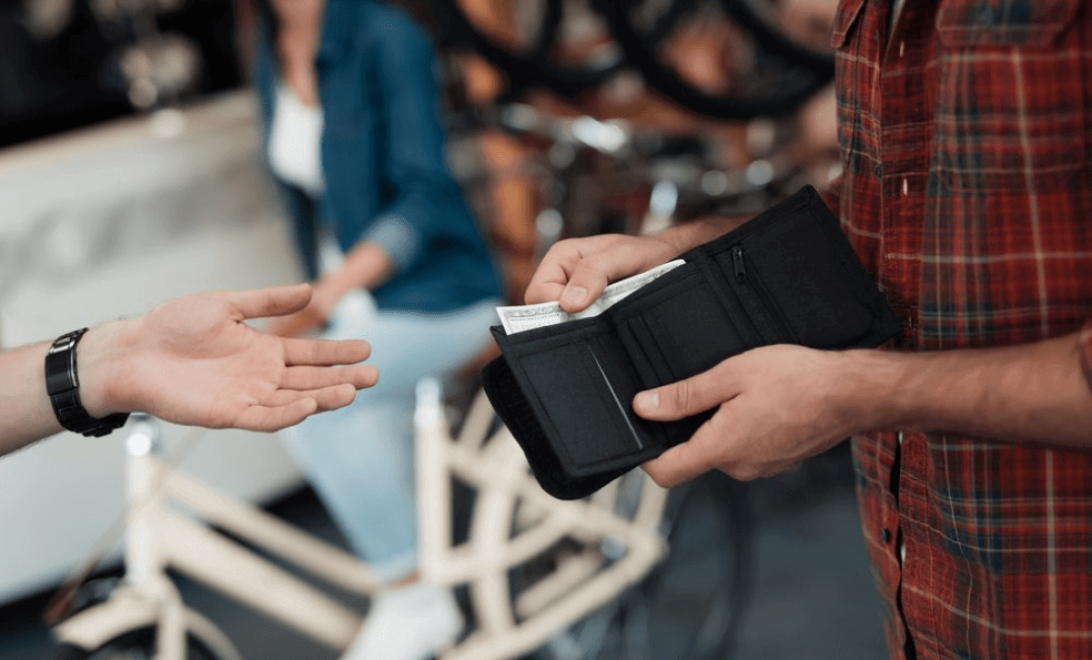 Person grabbing money out of their wallet