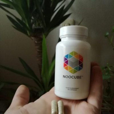 NooCube bottle NooCube supplement with two capsules in my hand