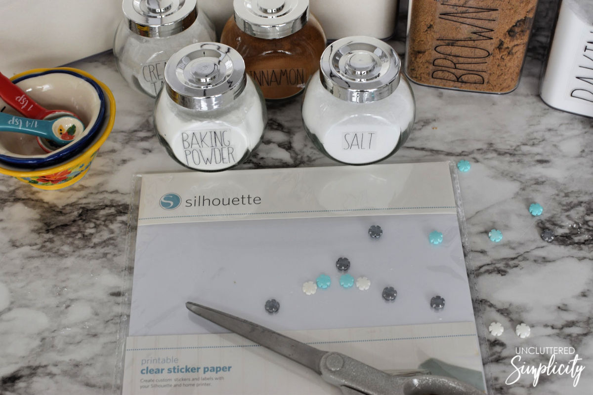 dry pantry items decanted into clear containers labeled with clear sticky labels.