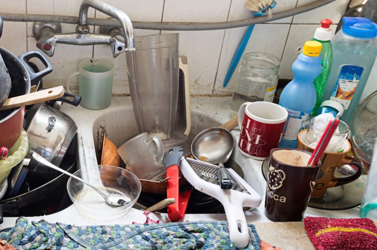 decluttering tips for hoarders-piles of dirty dishes in a dirty sink