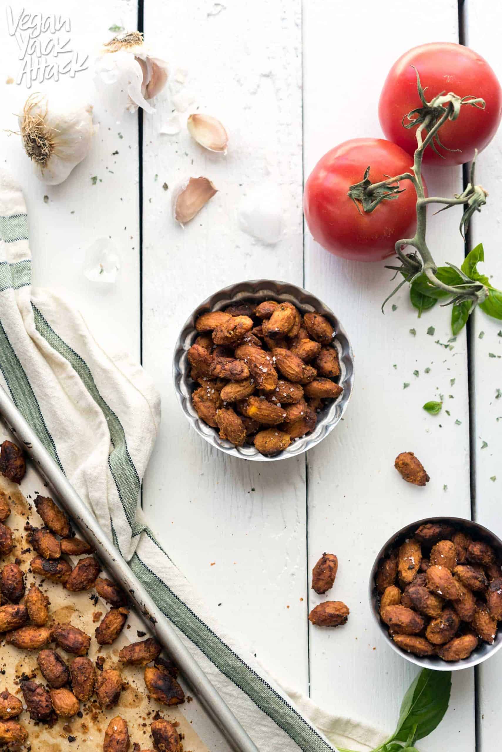 Image of pizza-roasted almonds in two small bowls on a white table