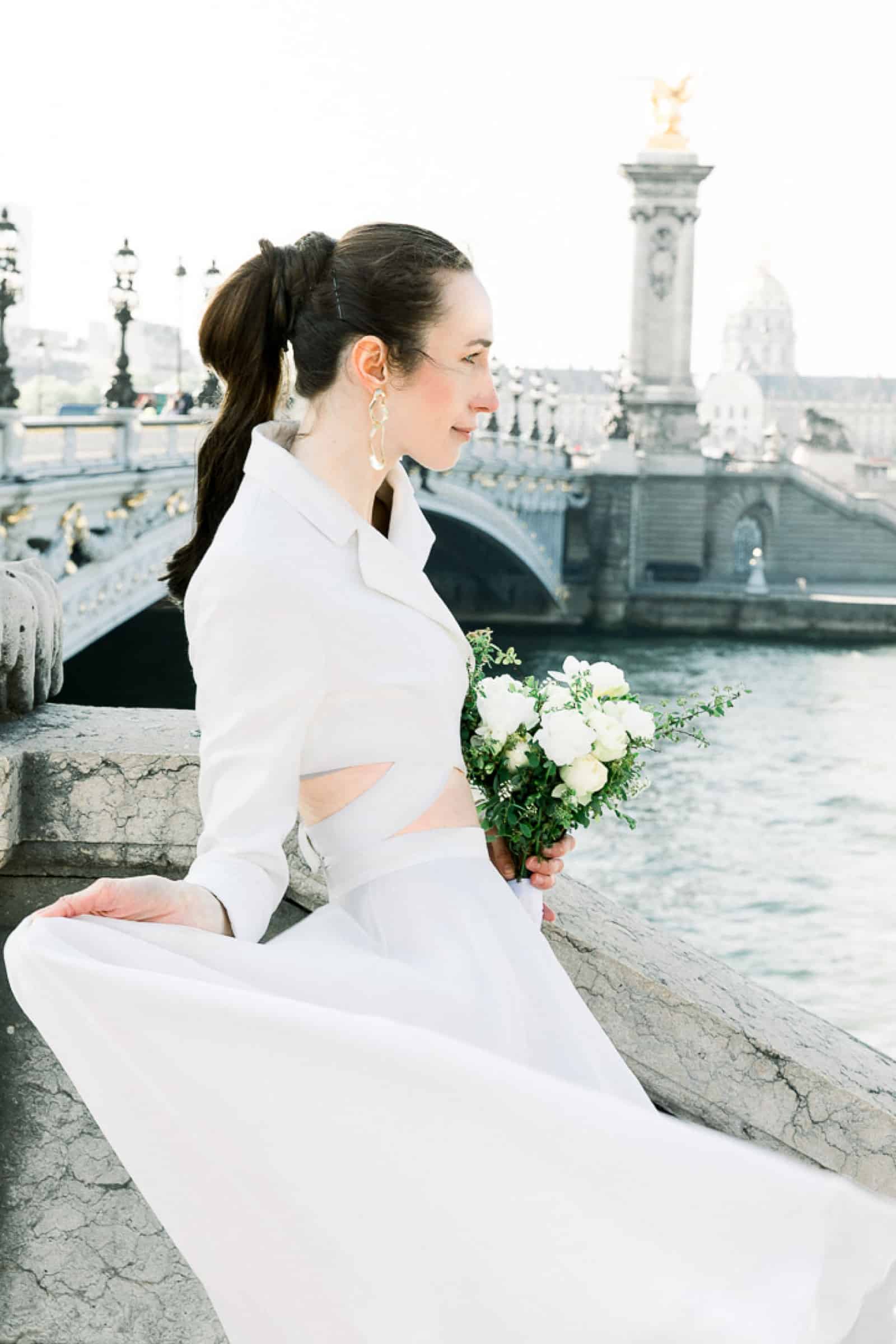 Modern high fashion bride in Paris, France at Pont Alexandre III bridge