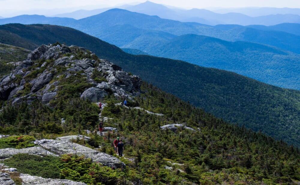 Hiking Trails Stowe VT A group of hikers walks along the ridge of Mt. Mansfield in Stowe, Vermont.