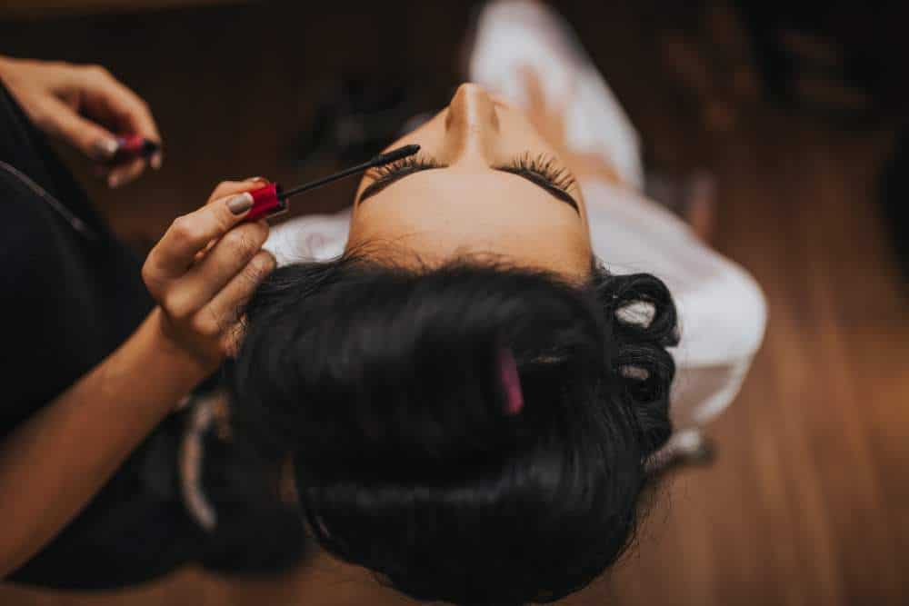 A make-up artist at work. Photo by Fernanda Prado on Unsplash