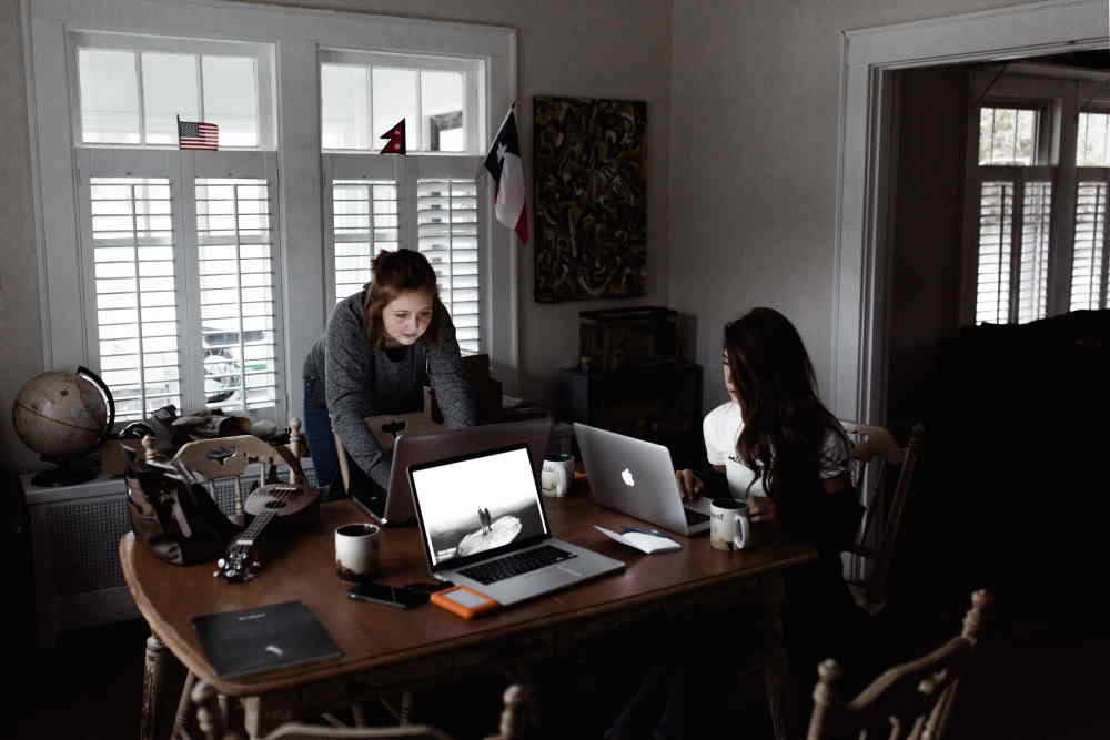 Two women working in an office. Photo by Andrew Neel