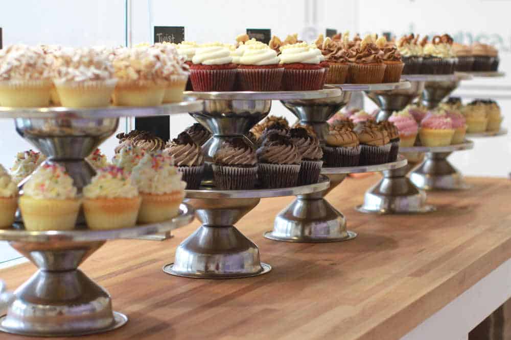 A photo of a counter full of cupcakes by Meghan Rodgers