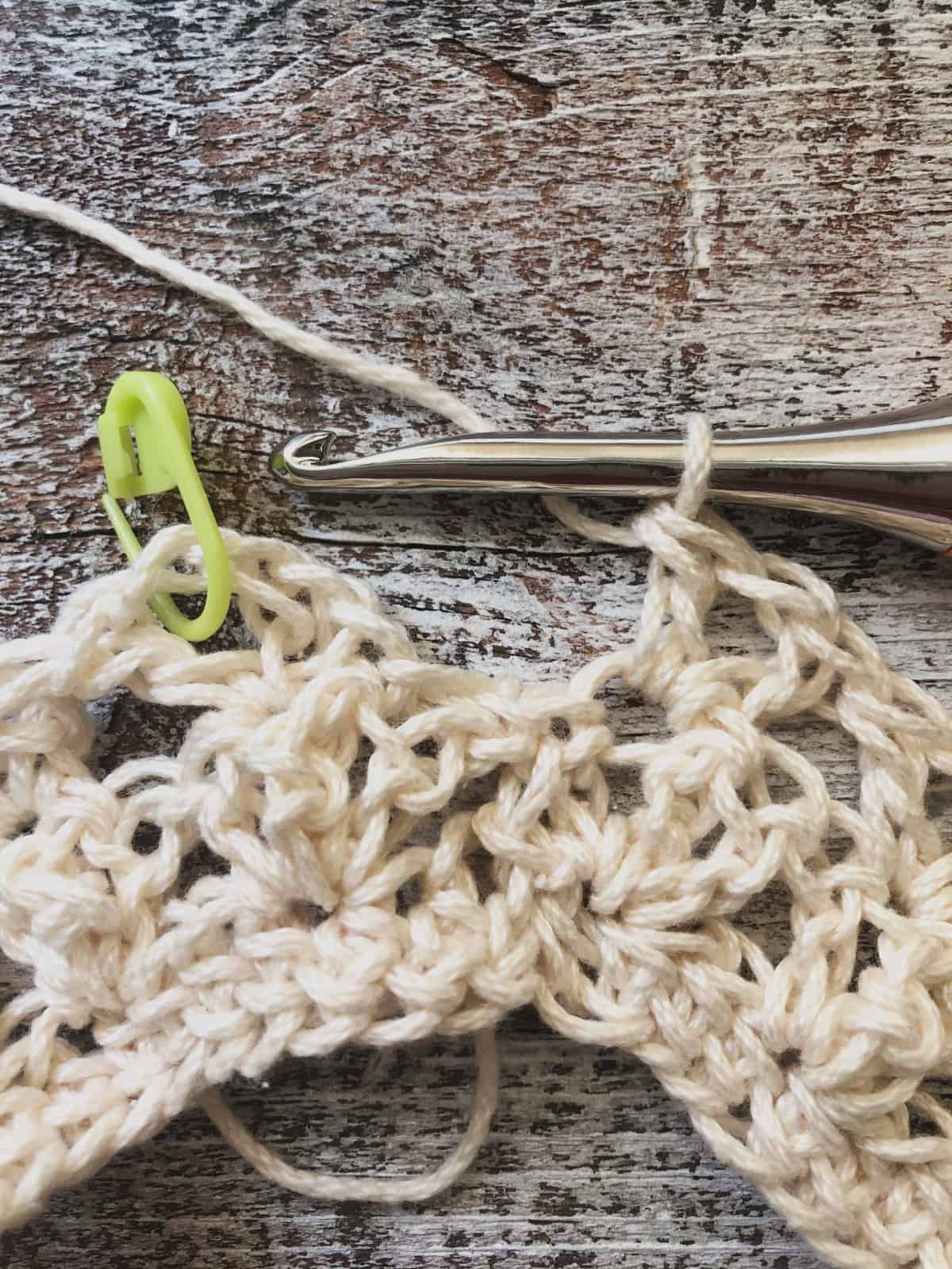 picture of end to row 3 with lime green st marker crochet tutorial