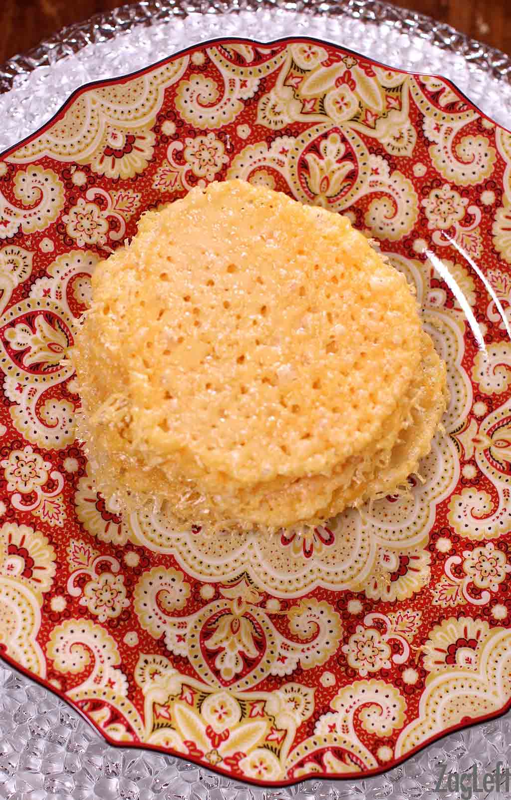 Parmesan cheese crisps stacked on a plate