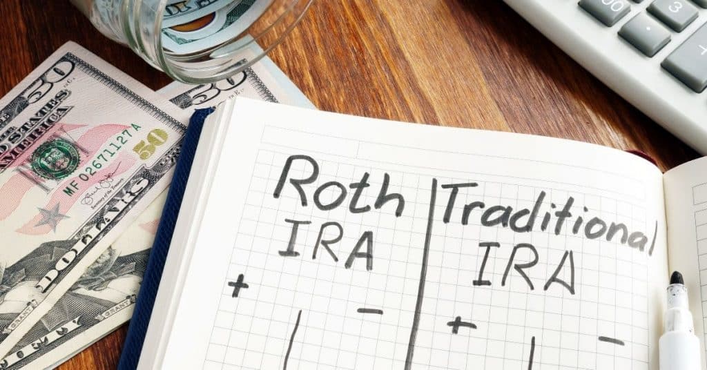 Open notebook with plus and minus columns for Roth vs. Traditional IRA's