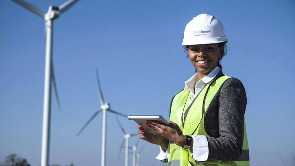 woman looking at table in front of wind turbines