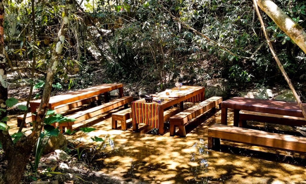 Picnic tables in a stream set with striped tablecloth