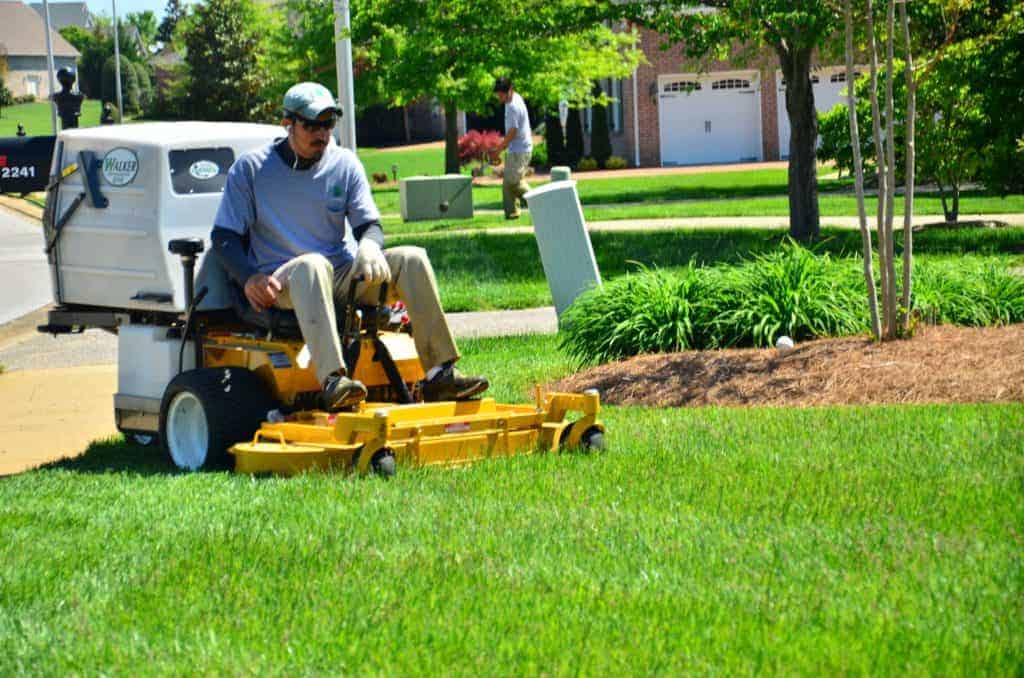 riding lawn mower over green field new clients