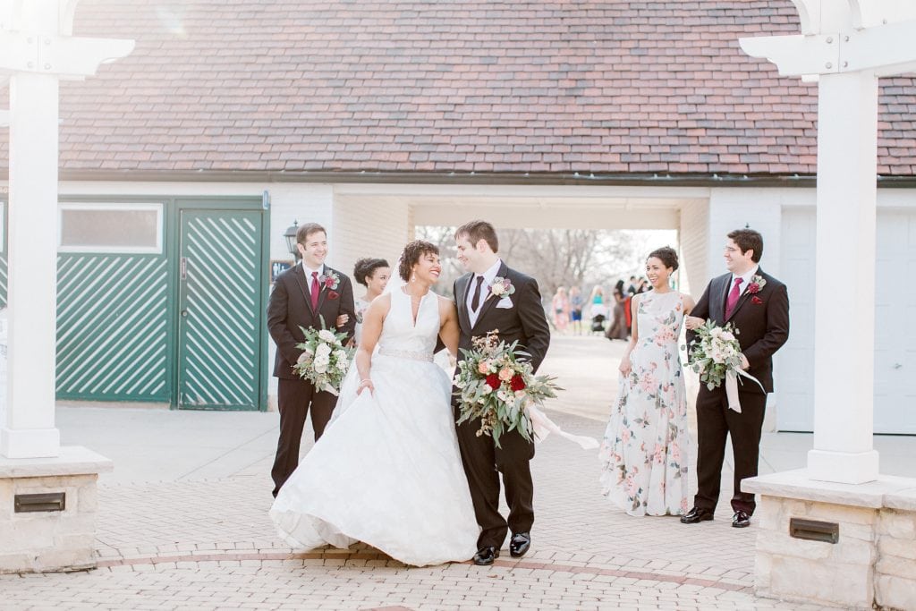 bridal party walking and laughing in front of the Chicago wedding venue danada house