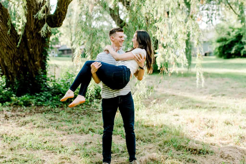 guy holding girl in her arms, engagement session in chicago