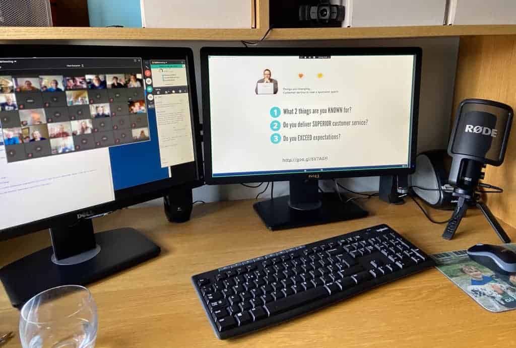 Webinar setup with dual screen, webcam, and dedicated Rode Microphone.