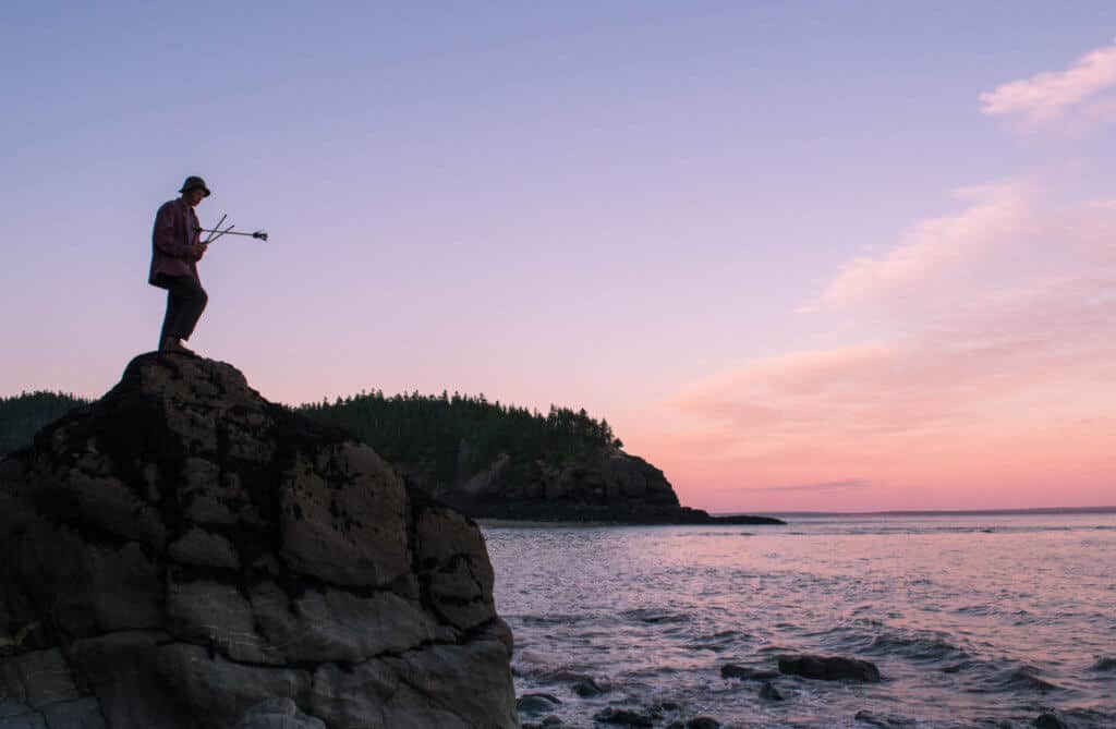 Point wolfe beach Fundy National Park A boy stands on a rock looking out at the Bay of Fundy tides in Fundy National Park.
