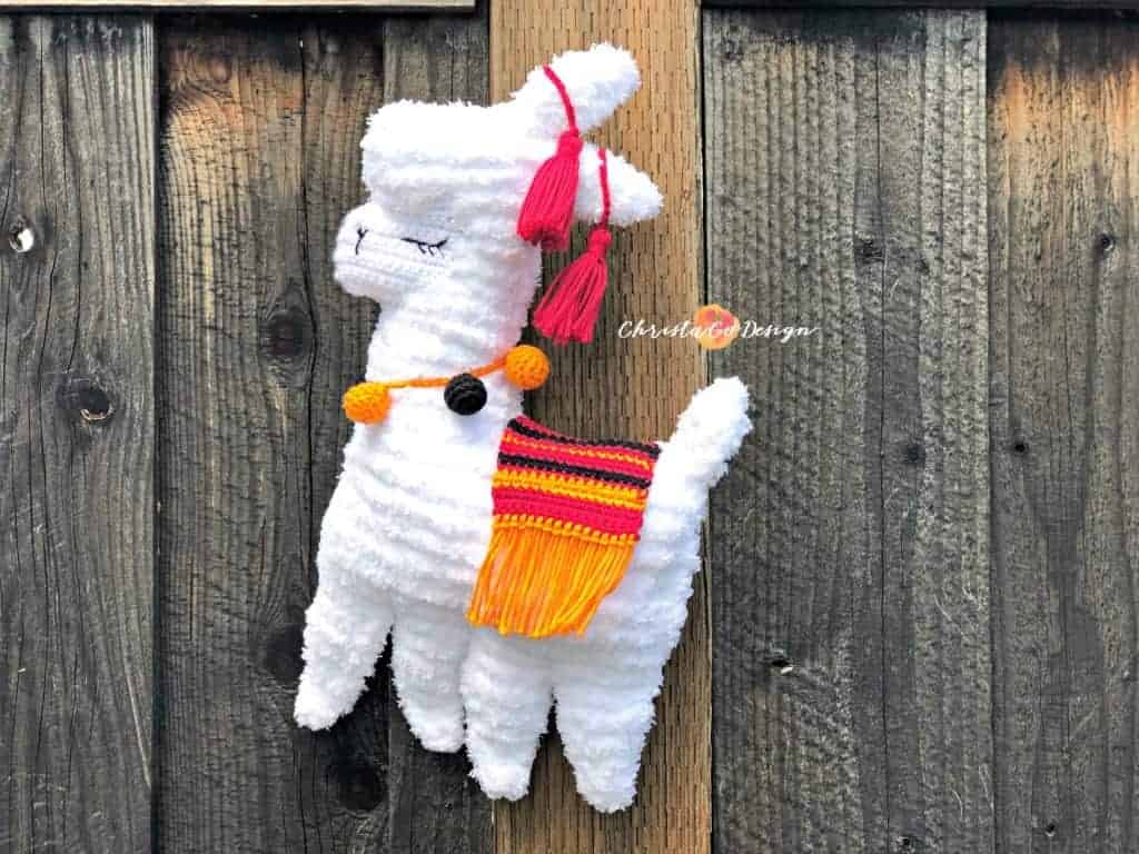 picture of fuzzy llama with orange blanket and baubles