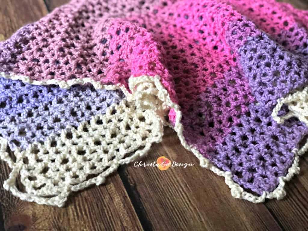 picture of pink and purple crochet lace poncho laid flat