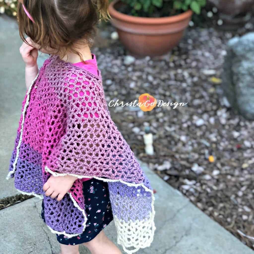 picture of toddler in pink merletto poncho