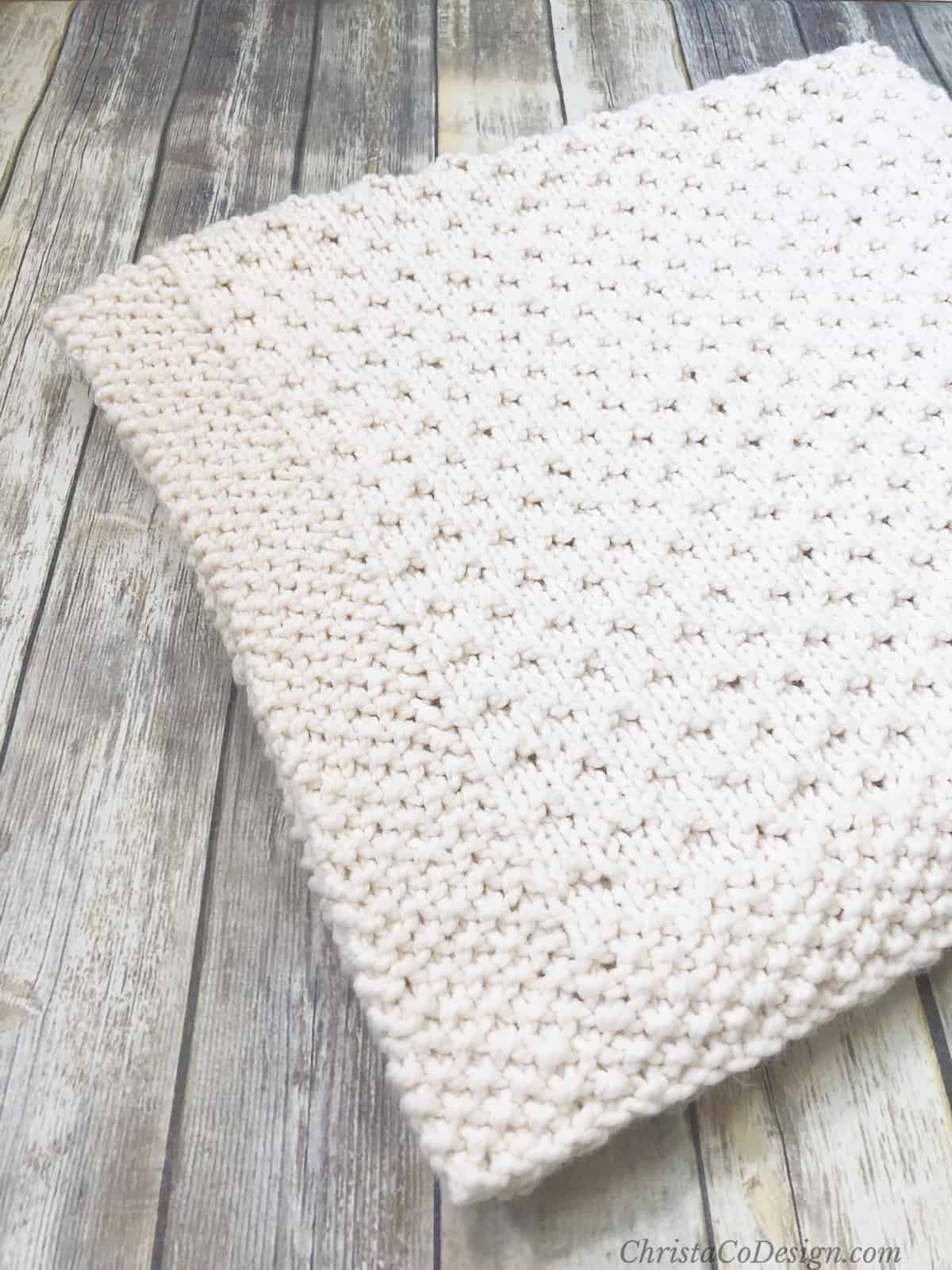picture of folded cream Bella vita knit blanket
