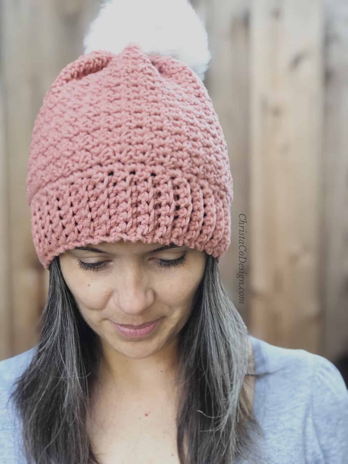 picture of pink bottom up hat crochet Positano pattern woman looking down