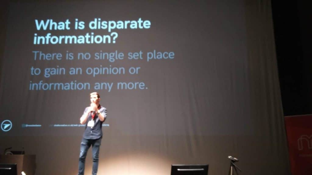 Chris Marr on stage with a slide asking: What is disparate information?'