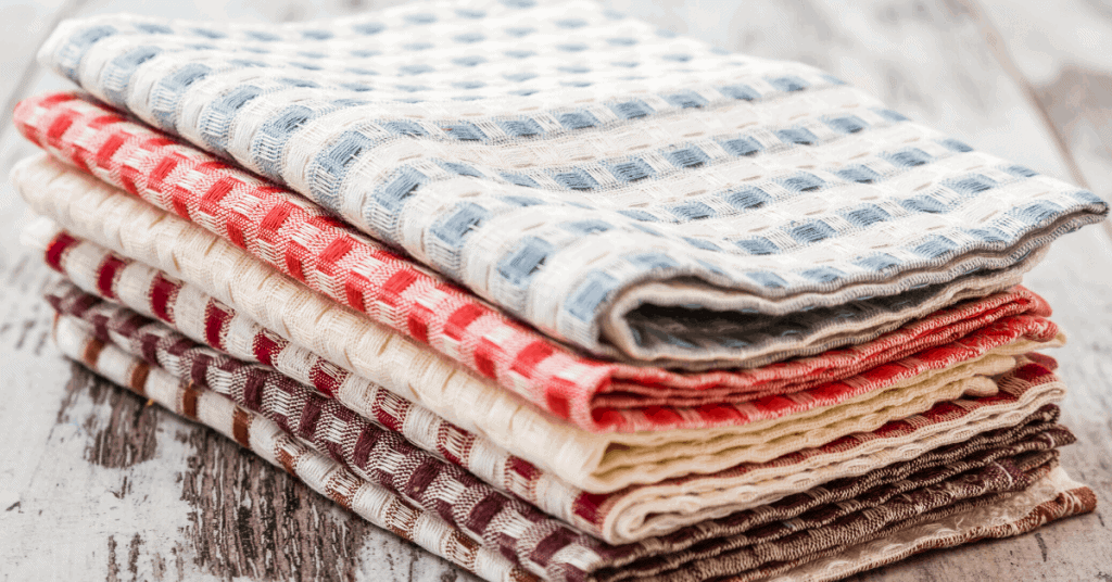 Close up of different linen cotton napkins on a rustic tabletop