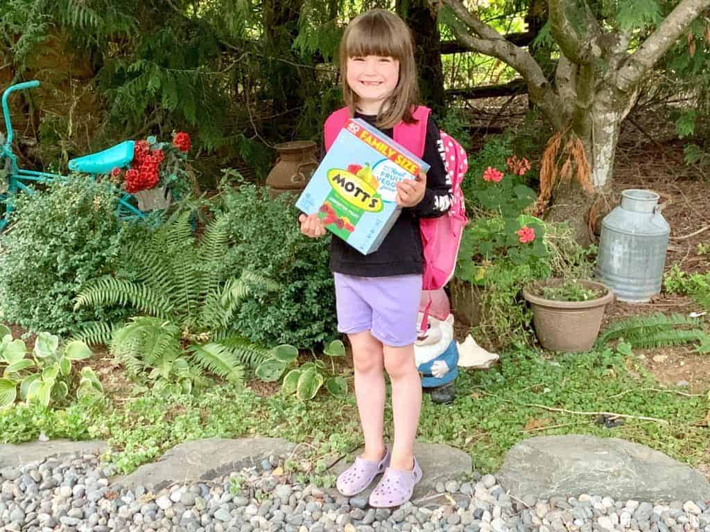 girl holding box of snacks