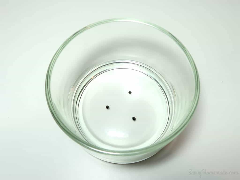 You can use non-permanent markers to dot place holders for where you want to stick your candle wicks down