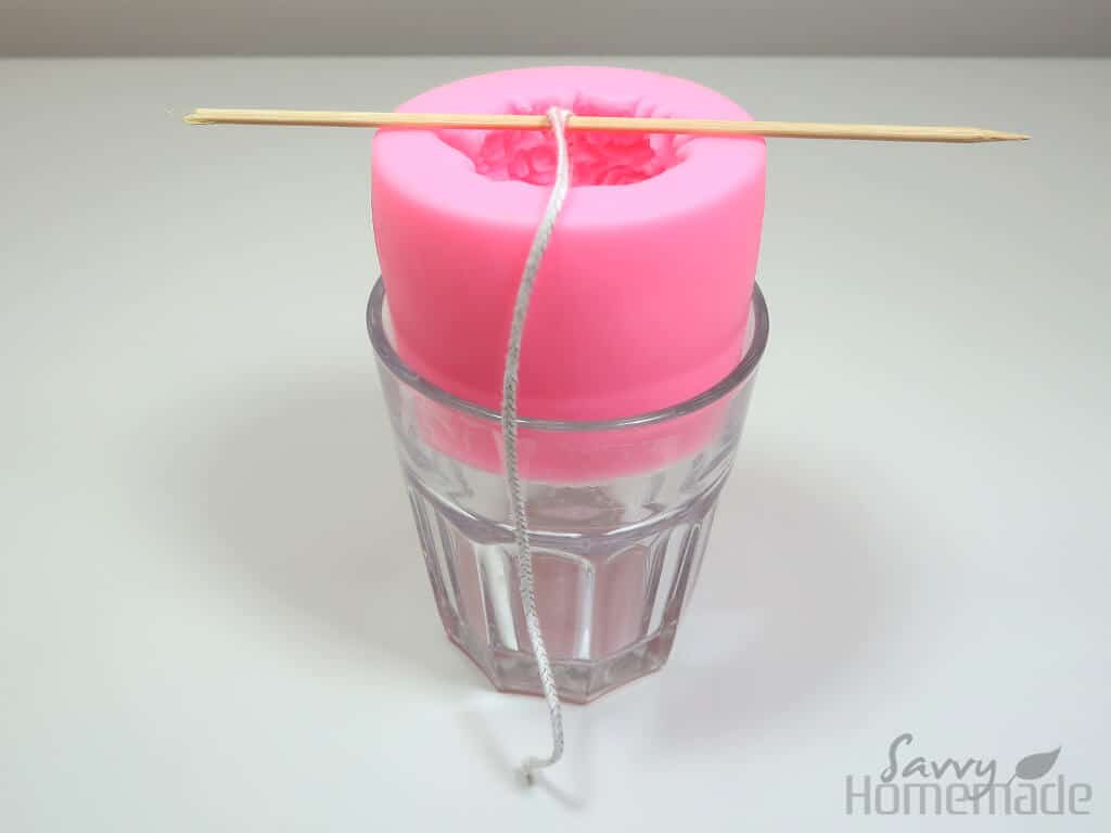 how to use silicon candle molds step 2: Use something to stablize your mold. I use a glass.