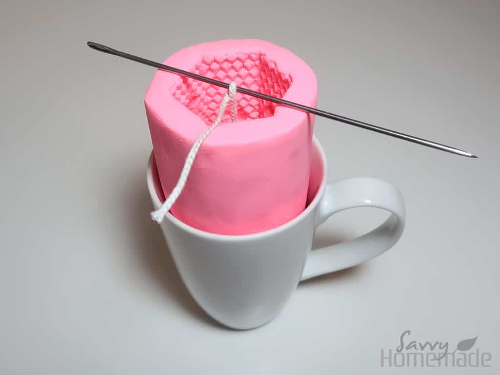 how to use silicon candle molds with beeswax step 2: Stablize your mold and use a pencil, wicking needle or peice of bamboo to hold the wick in place.
