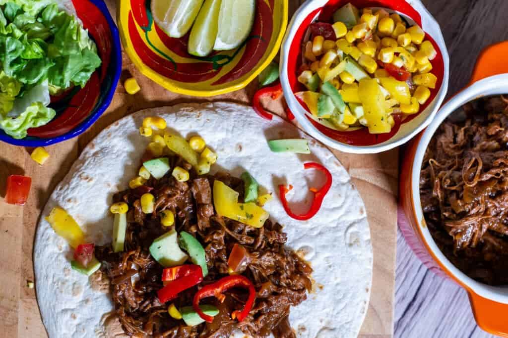 Slow Cooker Spicy Beef Tacos and accompaniments