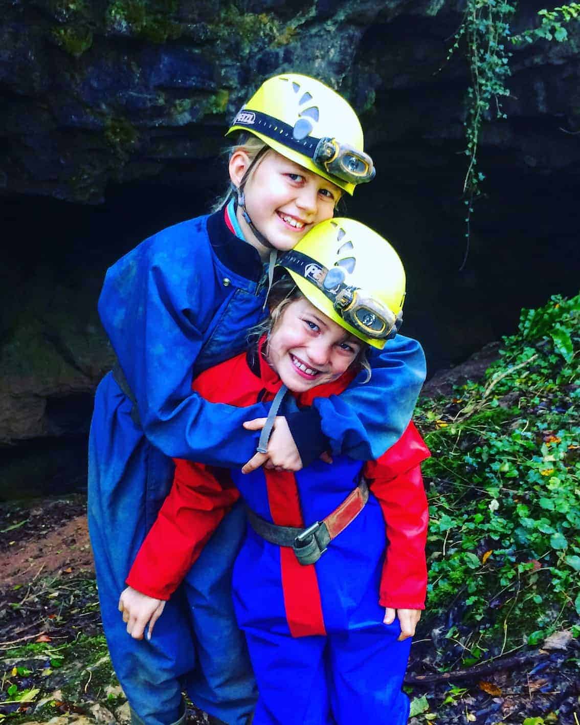 caving in devon. kids dressed in caving gear