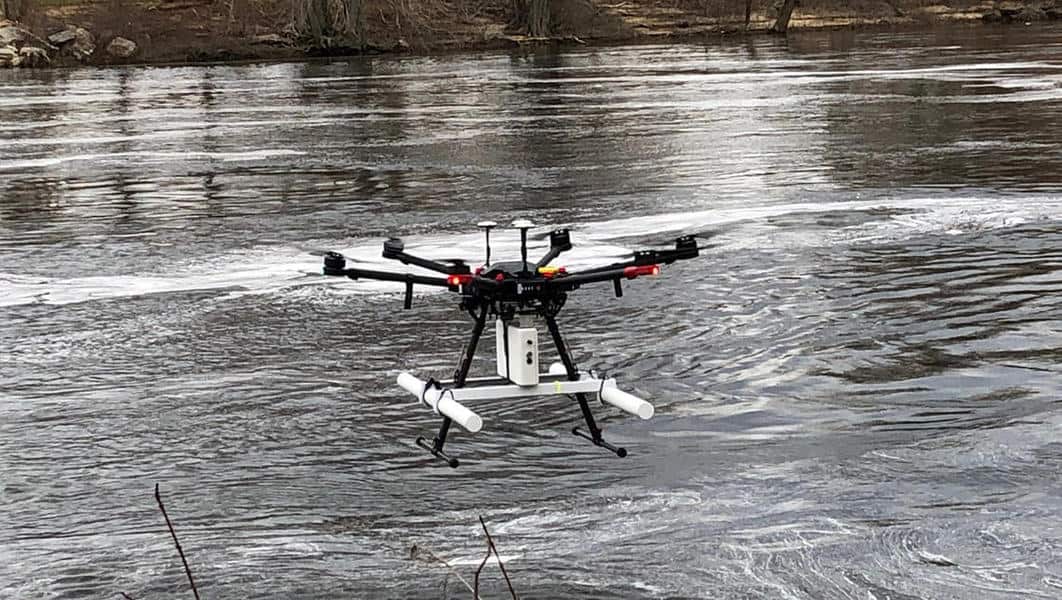 Drone with ground-penetrating radar system flying close over river surface. Photo: John W. Lane, USGS. Public domain.