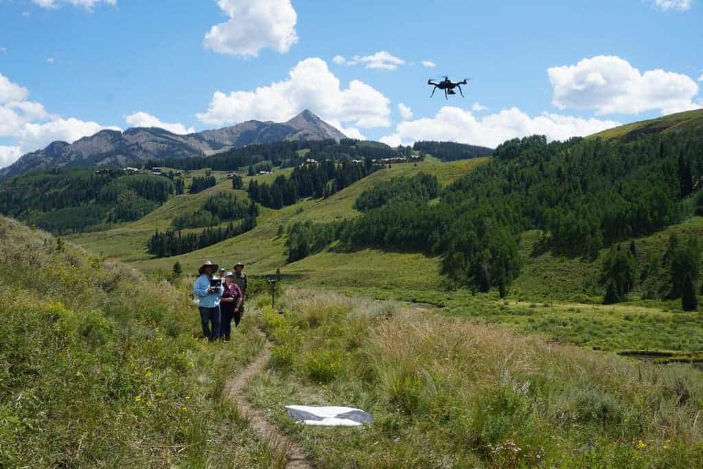 USGS scientists operate a small drone equipped with a thermal infrared camera during a groundwater/surface-water exchange study. Photo: USGS, public domain.