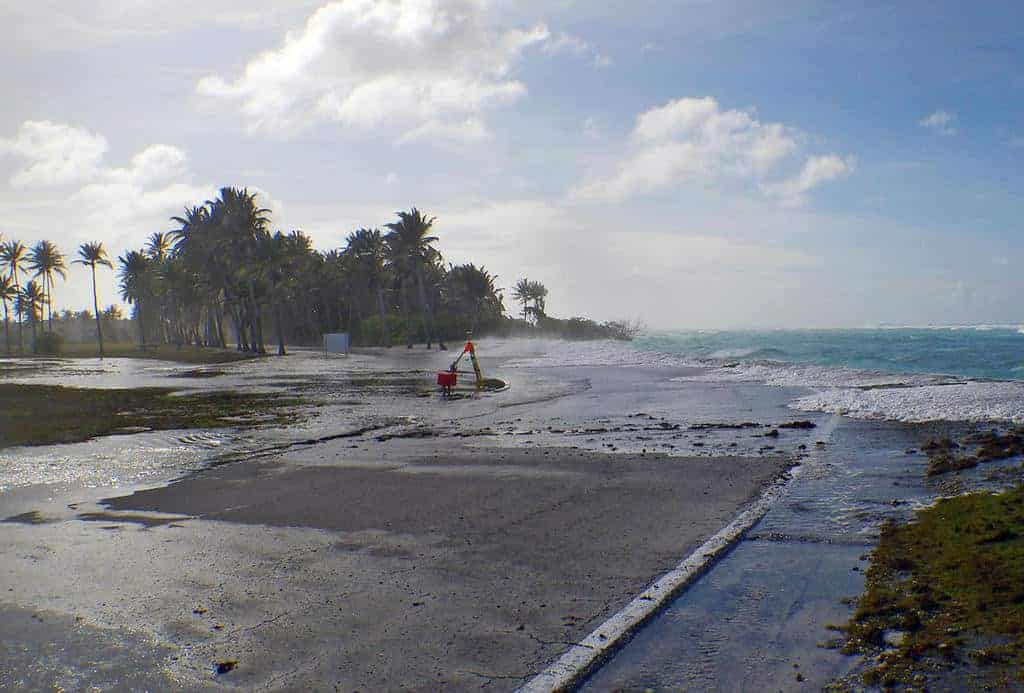 Sea level rise is a threat to low-lying coastal populations. Photo shows results of wave-driven flooding and overwash on Roi-Namur Atoll, Republic of the Marshall Islands. Photo: Peter Swarzenski, USGS. Public domain.