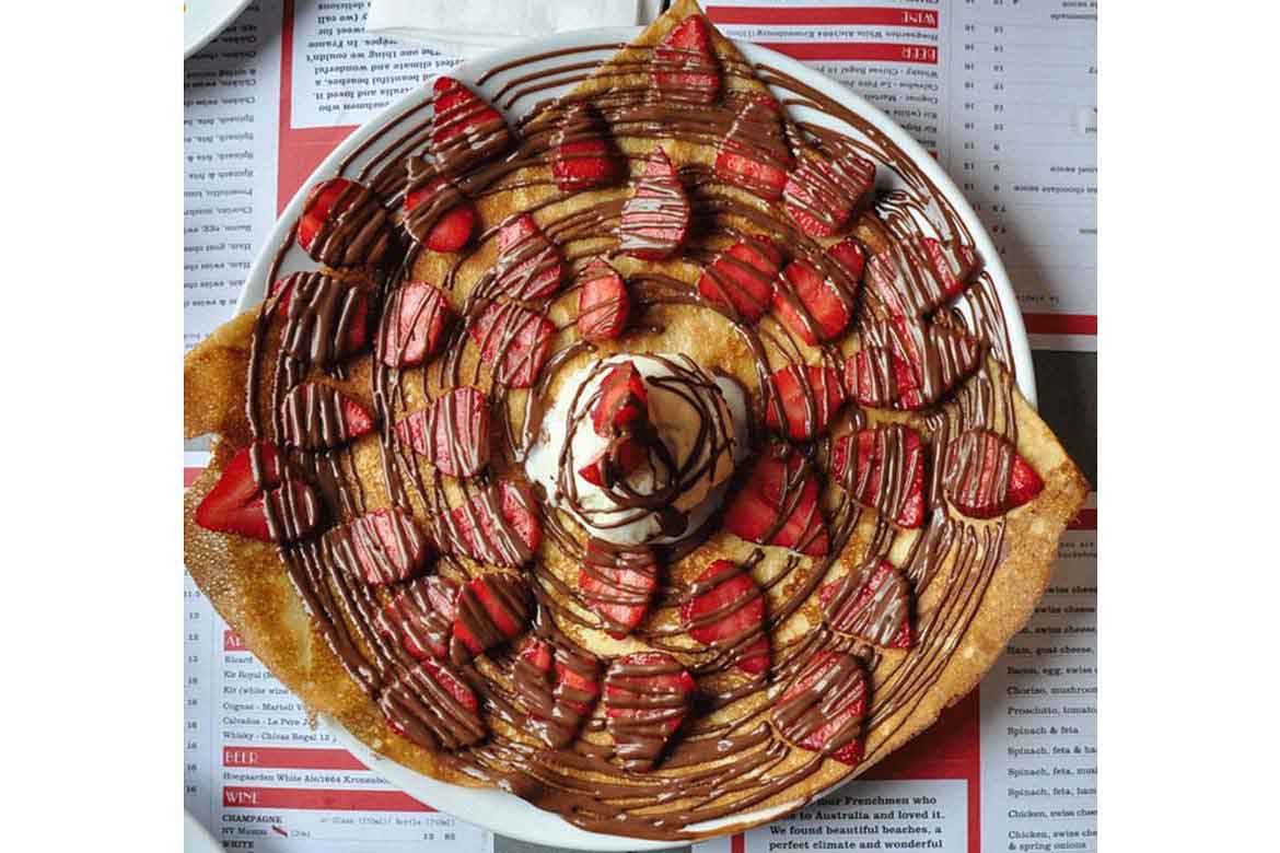 Crêpe with homemade chocolate sauce and fresh strawberries