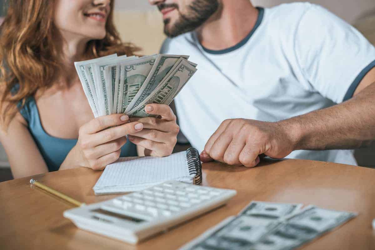 Man and woman sitting at table budgeting their money