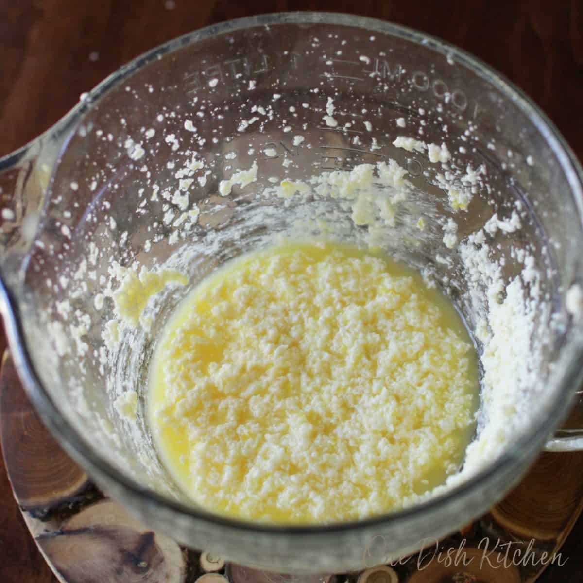 lemon curd in a mixing bowl on a brown table.