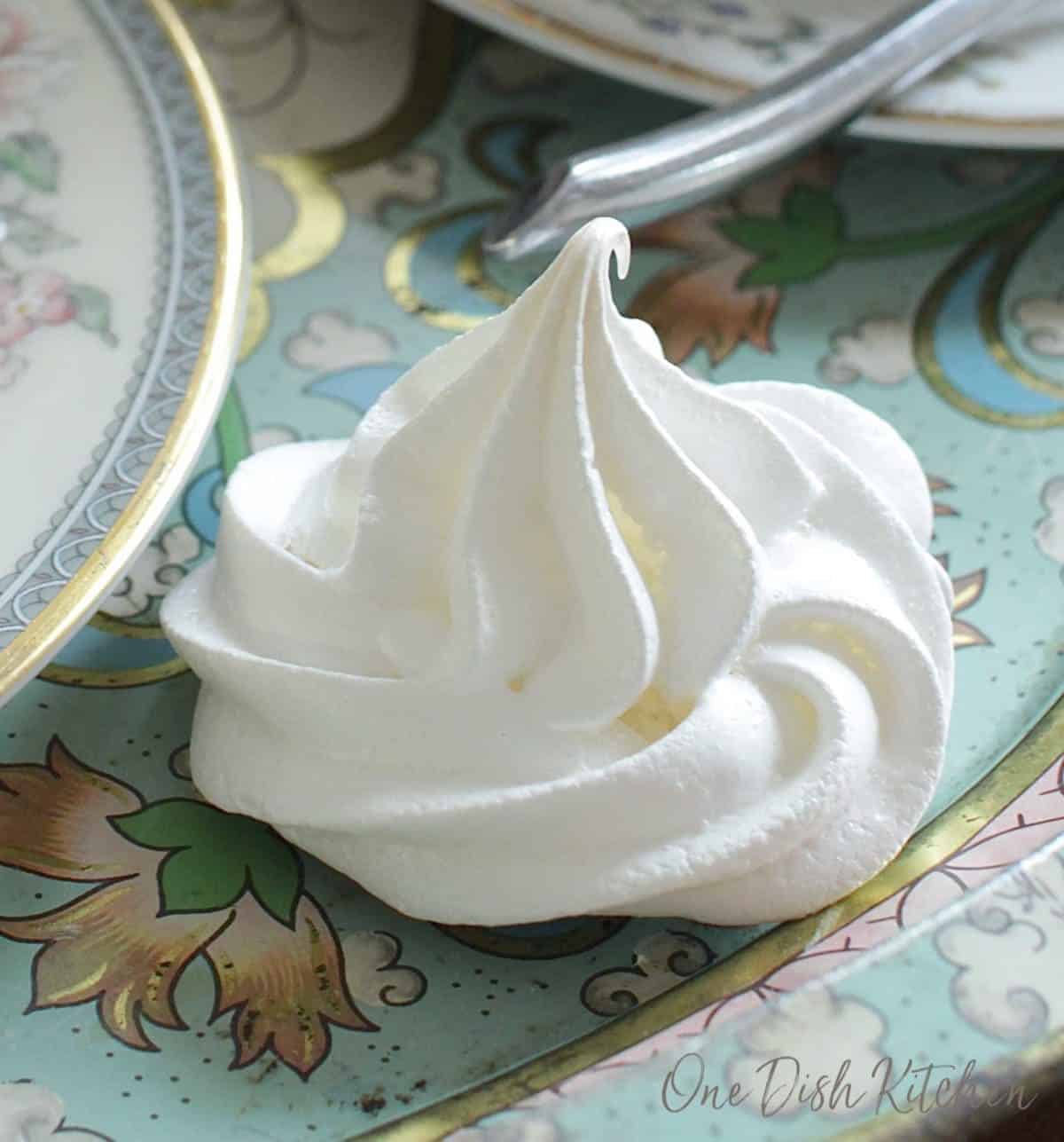 A closeup of a meringue cookie on a tray.