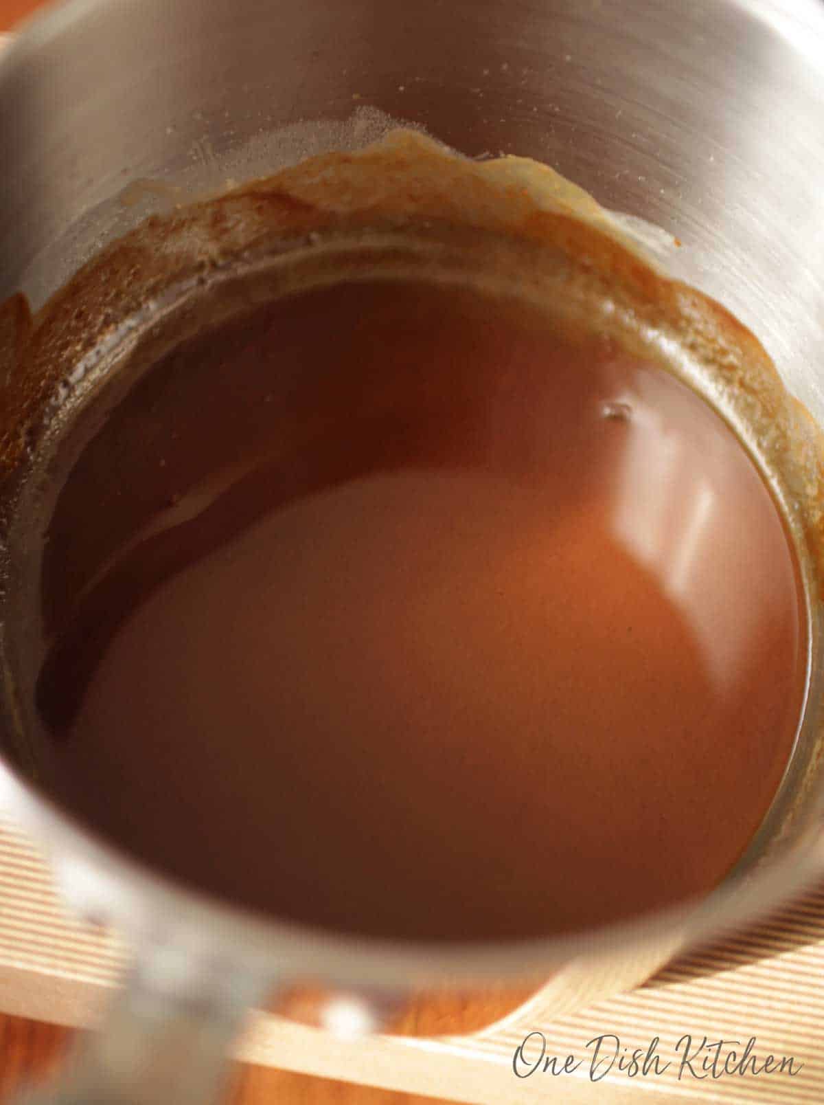 Brown roux in a stainless steel pot.