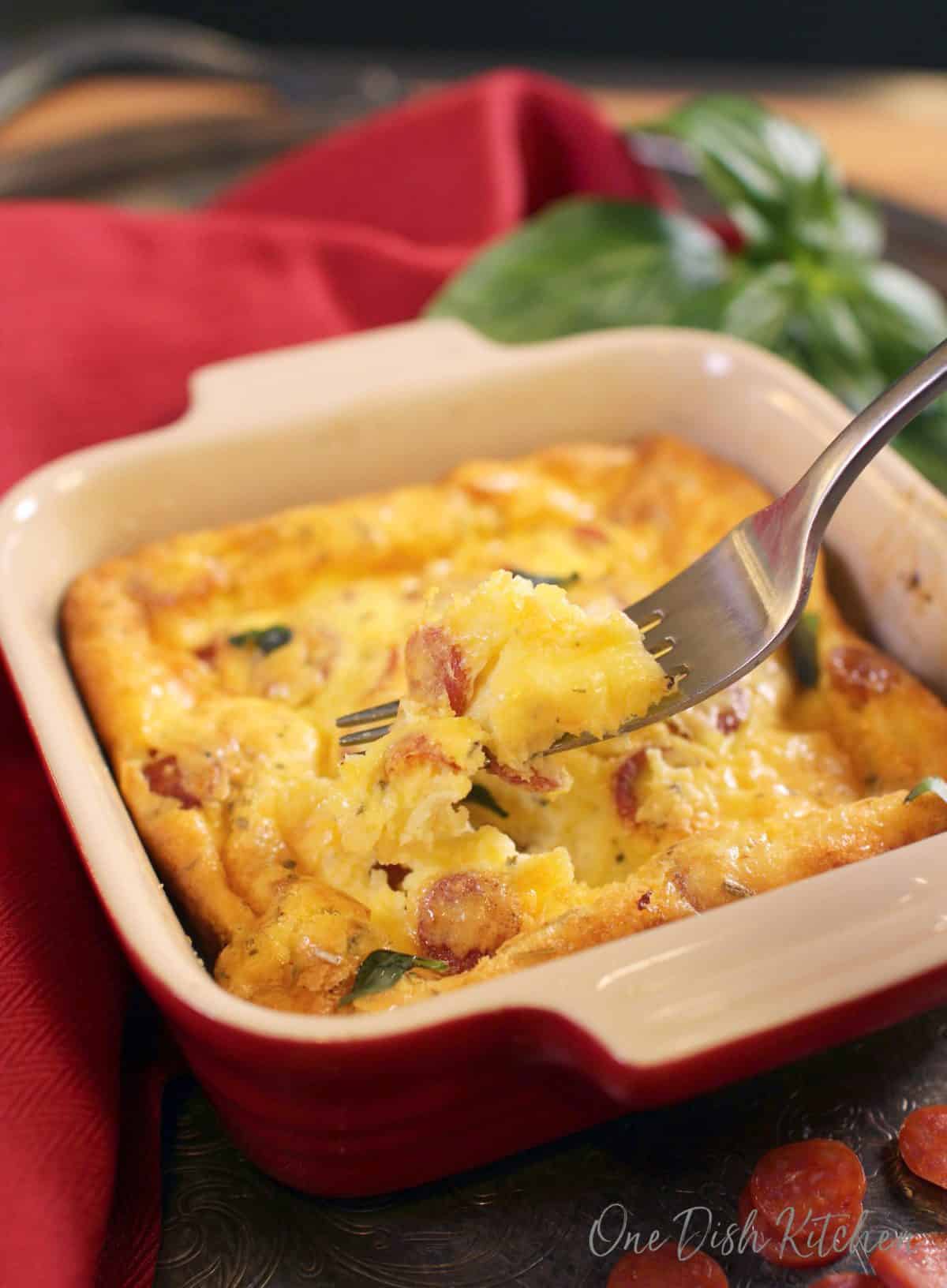 a fork scooping out a bit of quiche.