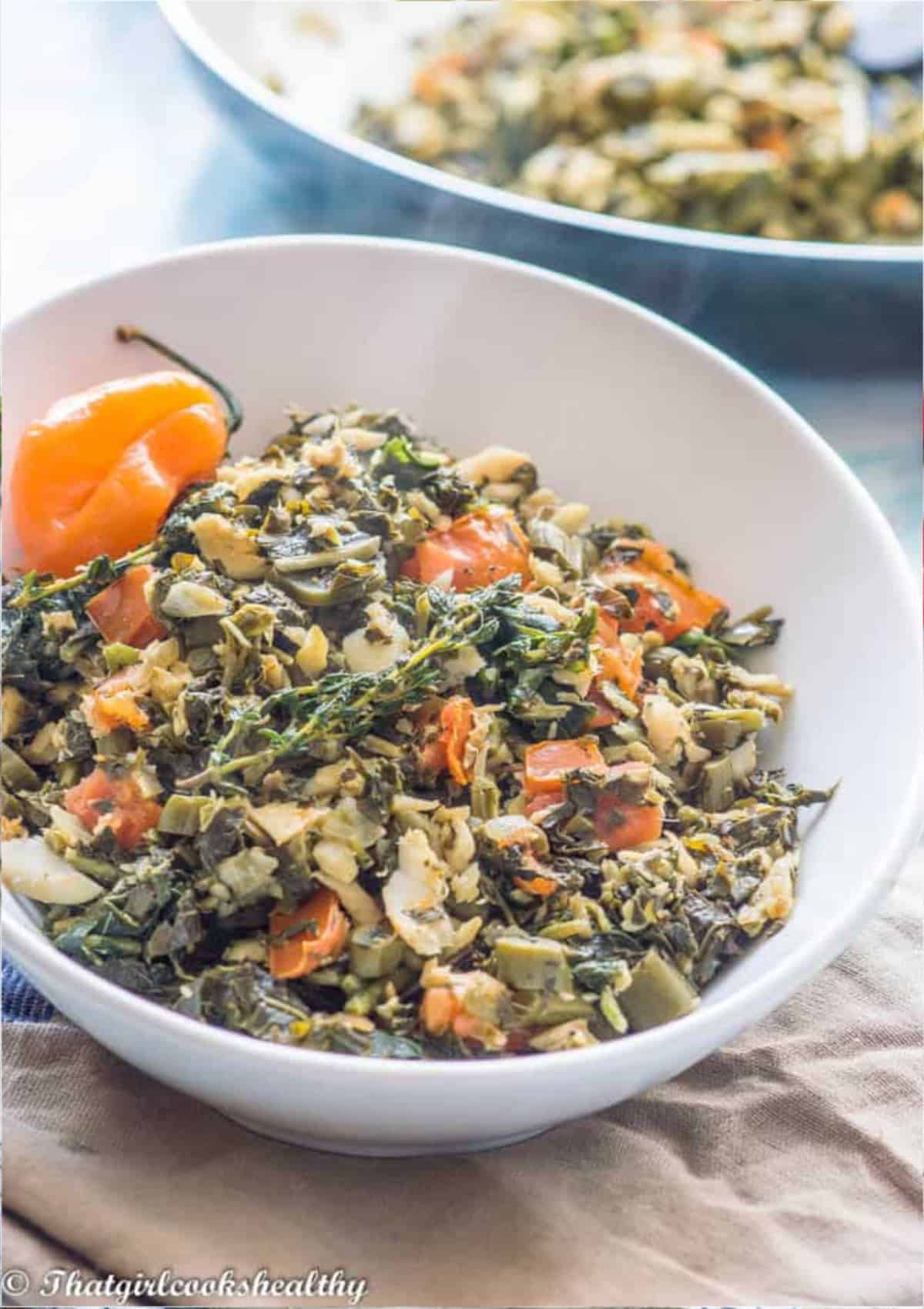 Colourful bowl of saltfish with some callaloo