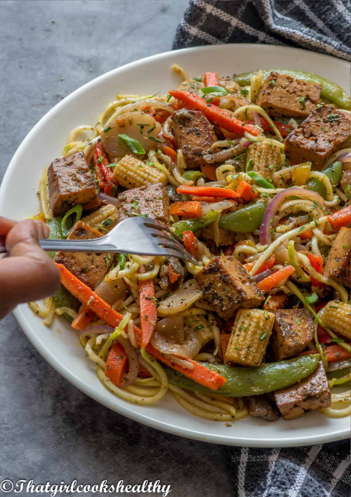 Fork scooping the tofu noodles