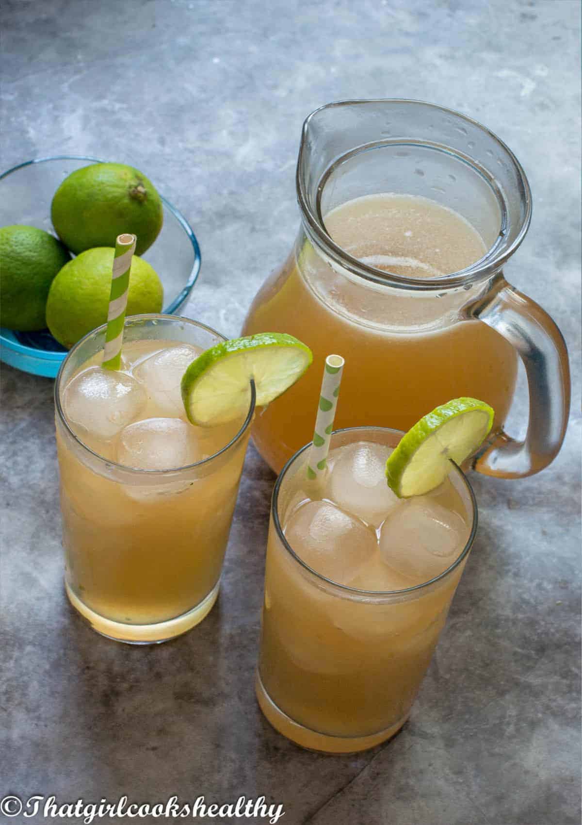 two glasses of lemonade with a jug