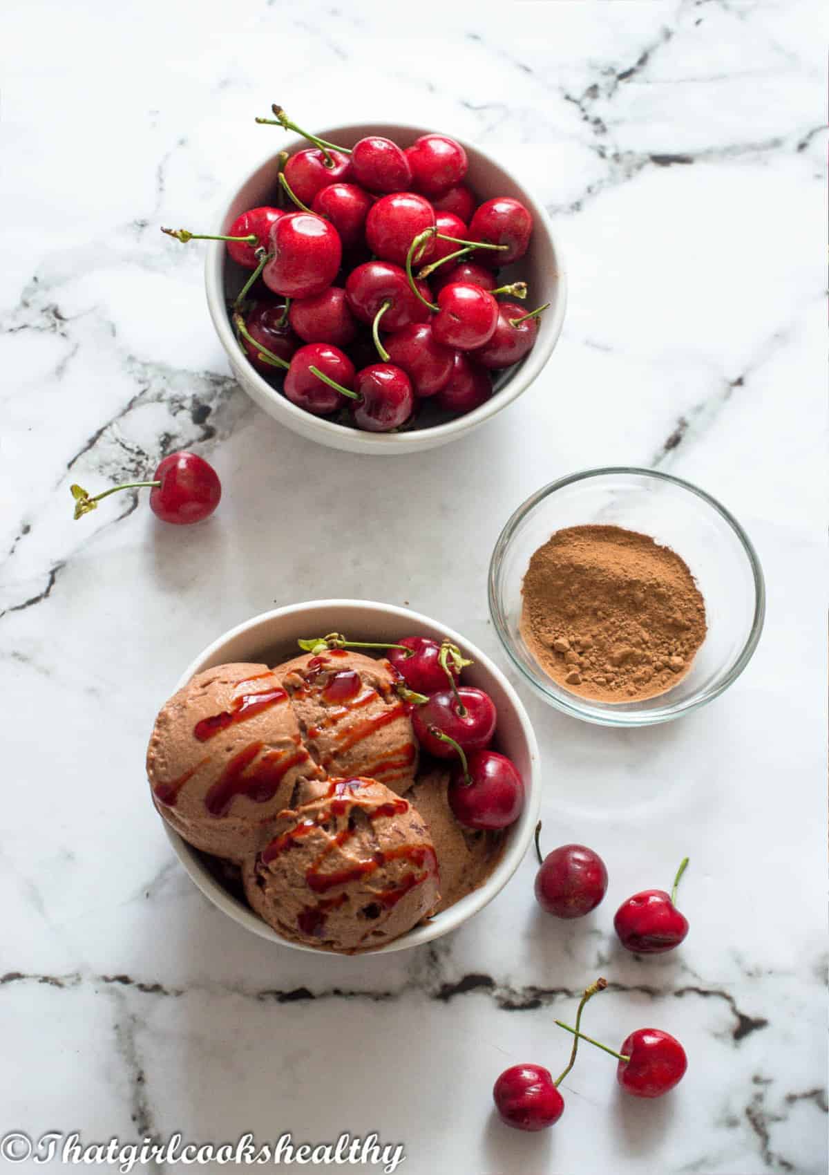 ice cream in a bowl with loose cherries