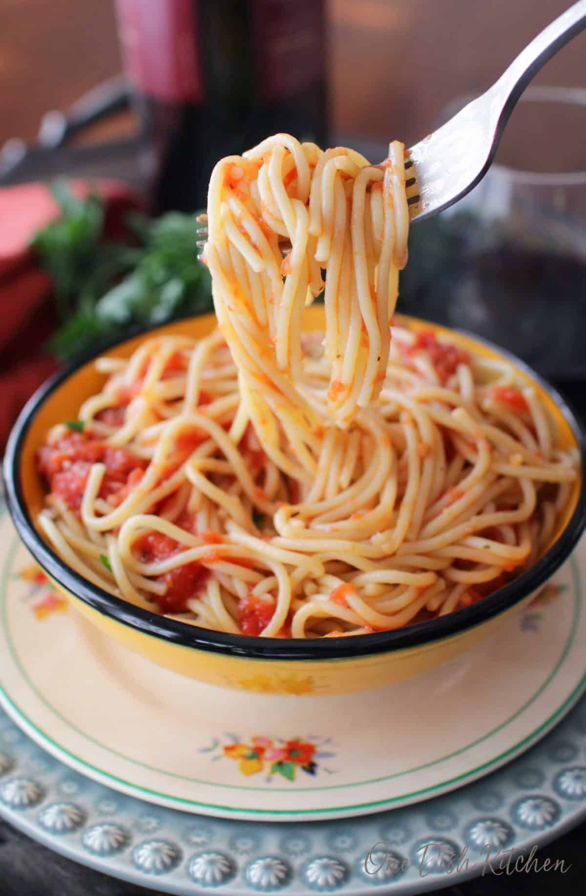 A closeup of spaghetti hanging from a fork