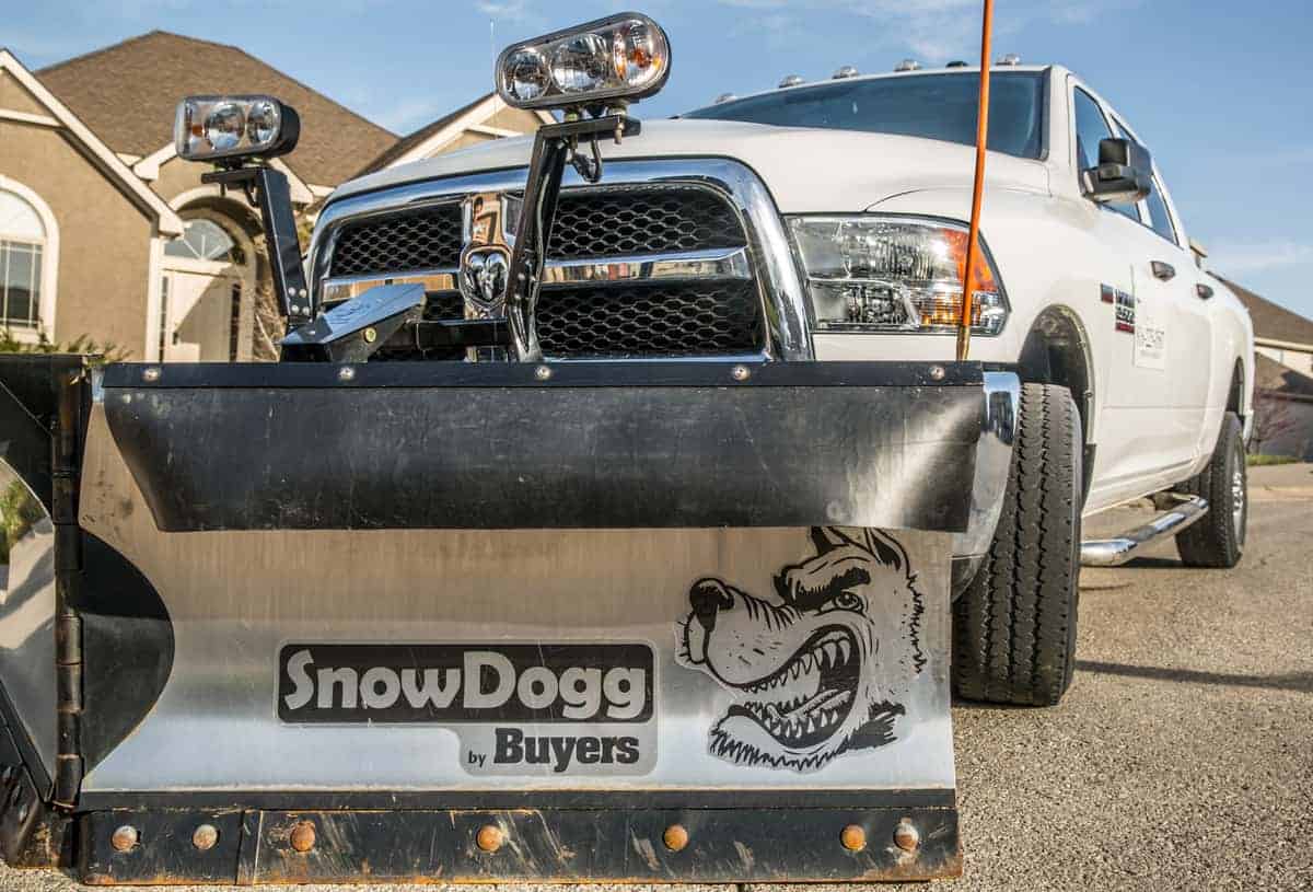 Snow plow hooked up to a pickup truck