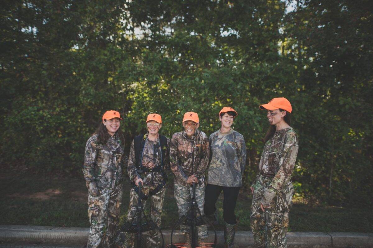 Women hunters posing before a hunt